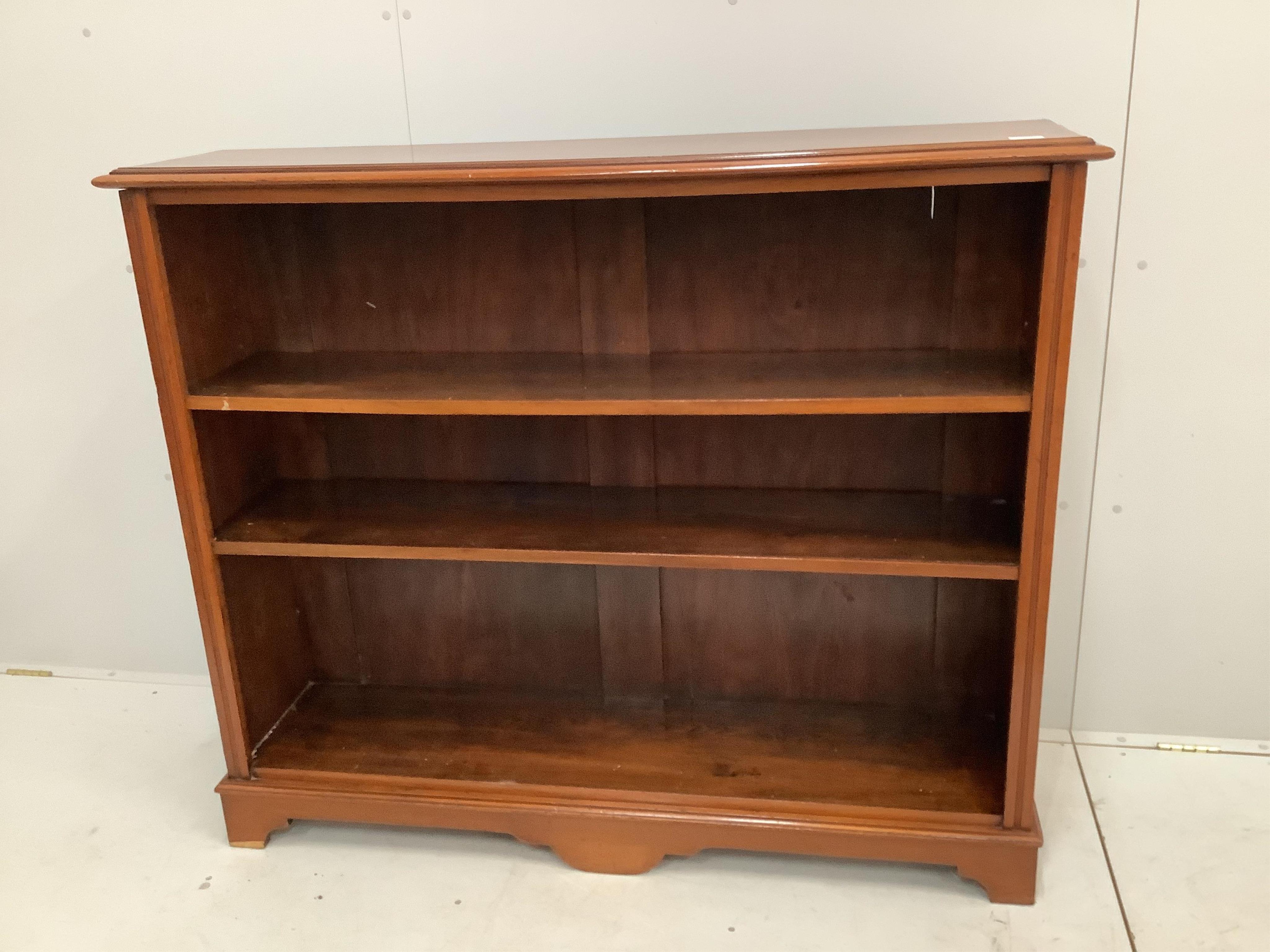 A reproduction Victorian style walnut open bookcase, width 135cm, depth 32cm, height 114cm. Condition - good